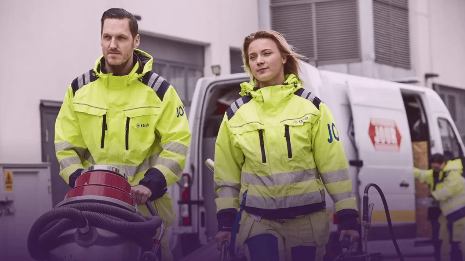 Two Ocab sanitation technicians in safety gear by their service van